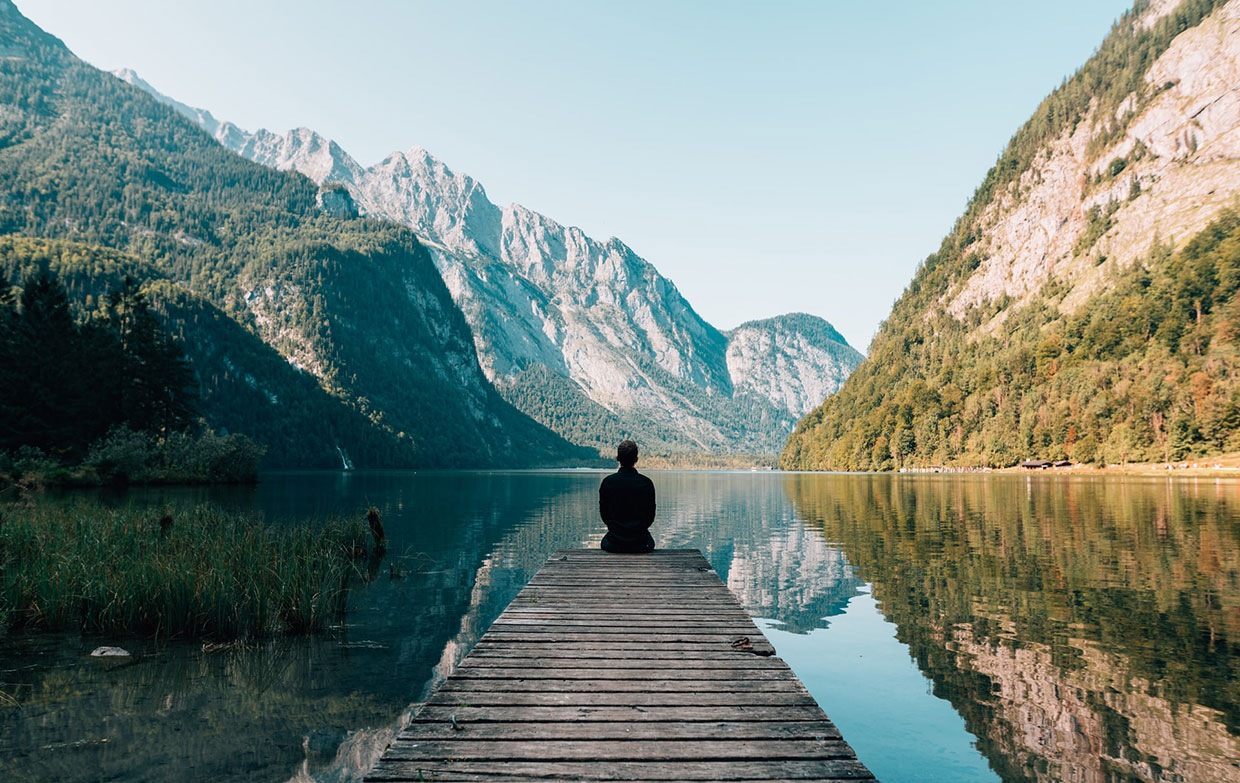 Man sitting on grey dock